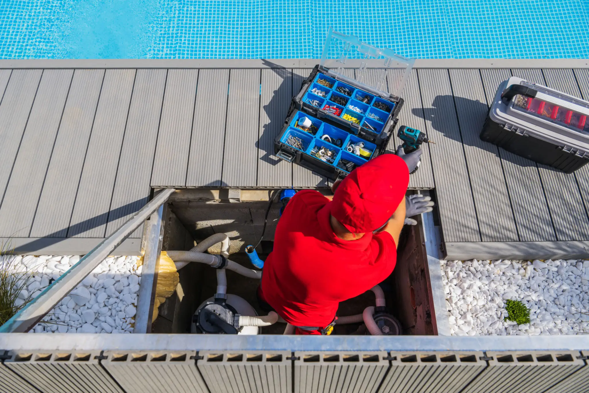 Technician repairing poolside machinery